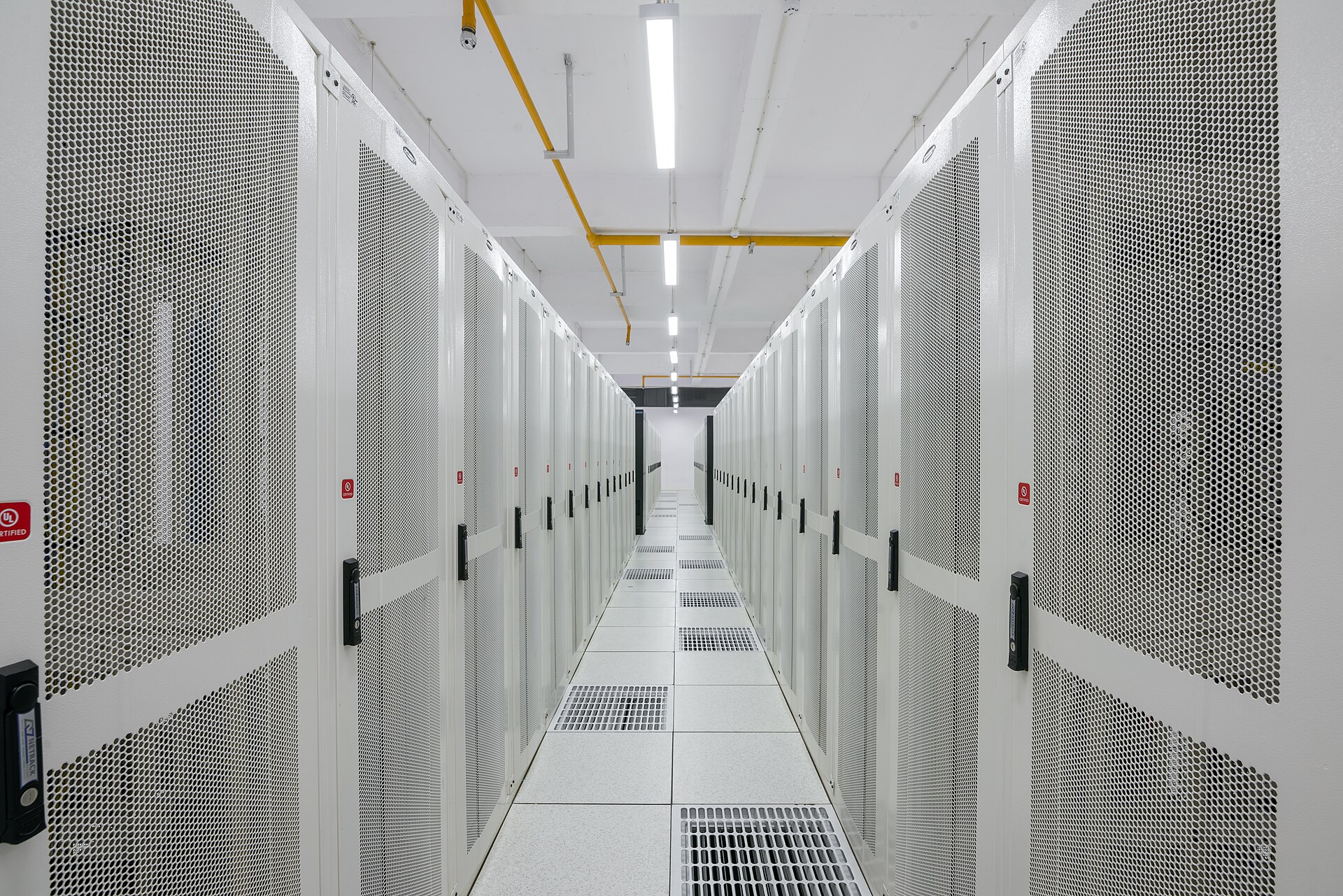 Server racks illustrating website hosting infrastructure, one core line item in a new site budget alongside domain and maintenance