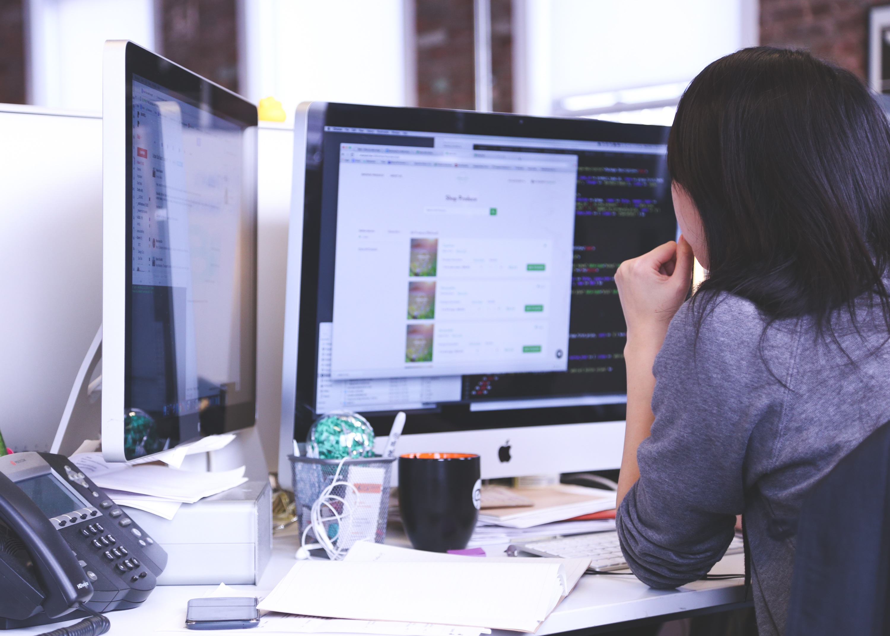 Designer reviewing a live website on desktop screens